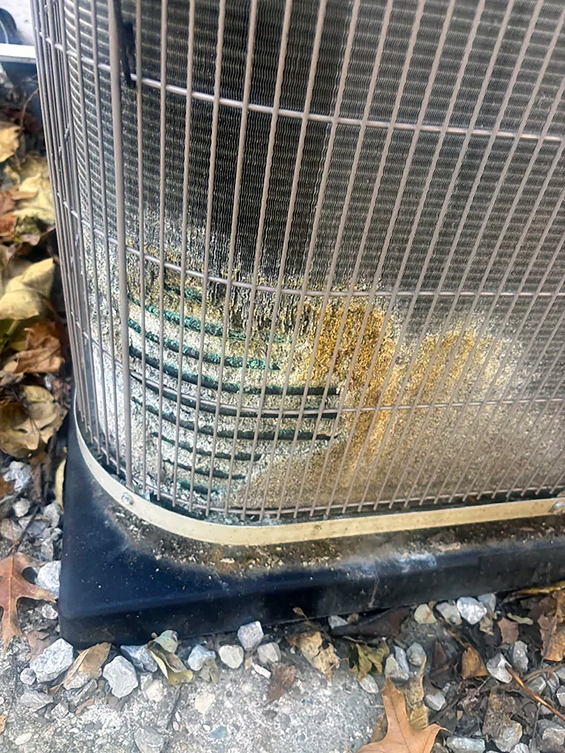 Outdoor condenser coil showing corrosion and environmental wear