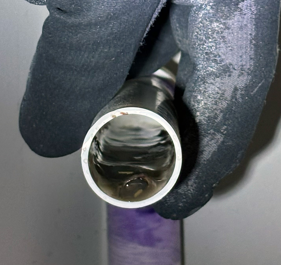 HVAC drain pan showing buildup, rust, and maintenance concerns
